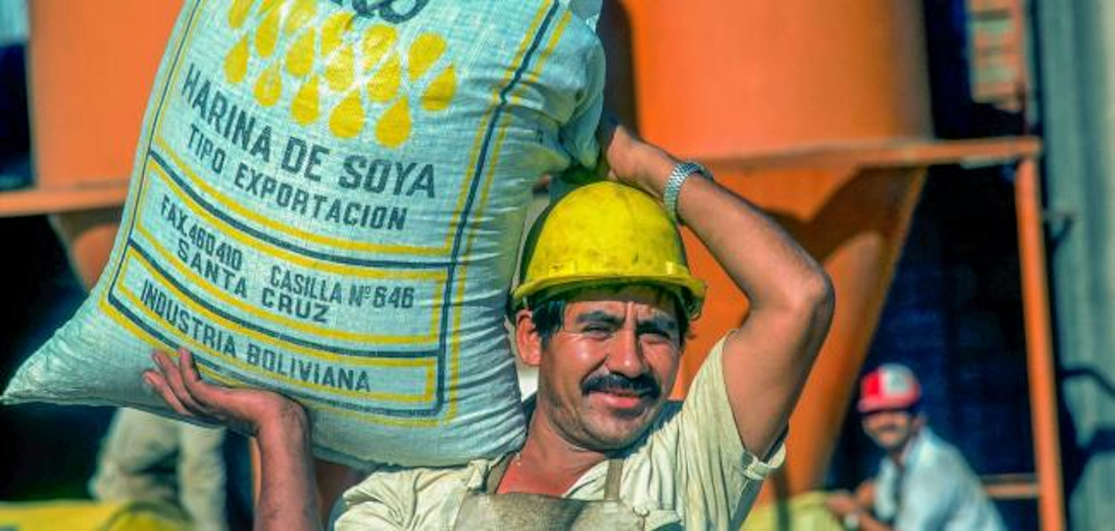 worker carrying soy bag, Bolivia