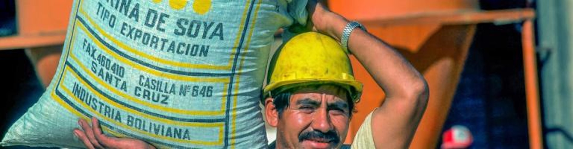 worker carrying soy bag, Bolivia