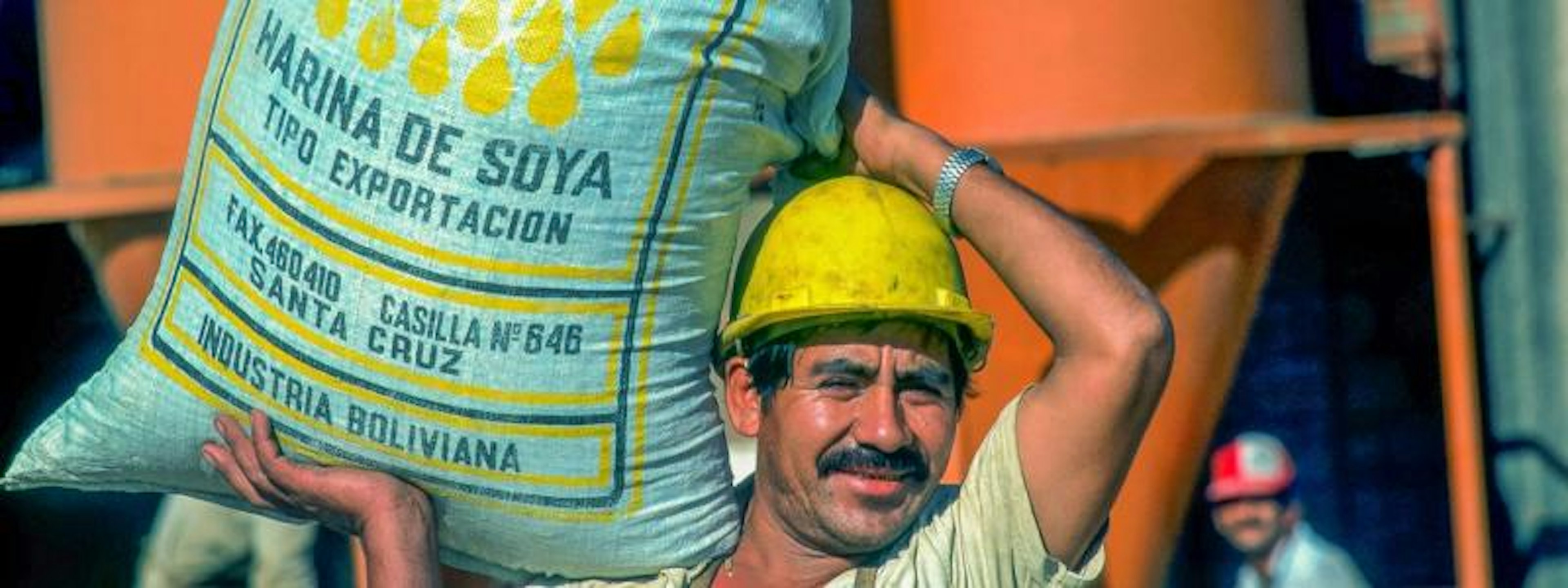 worker carrying soy bag, Bolivia