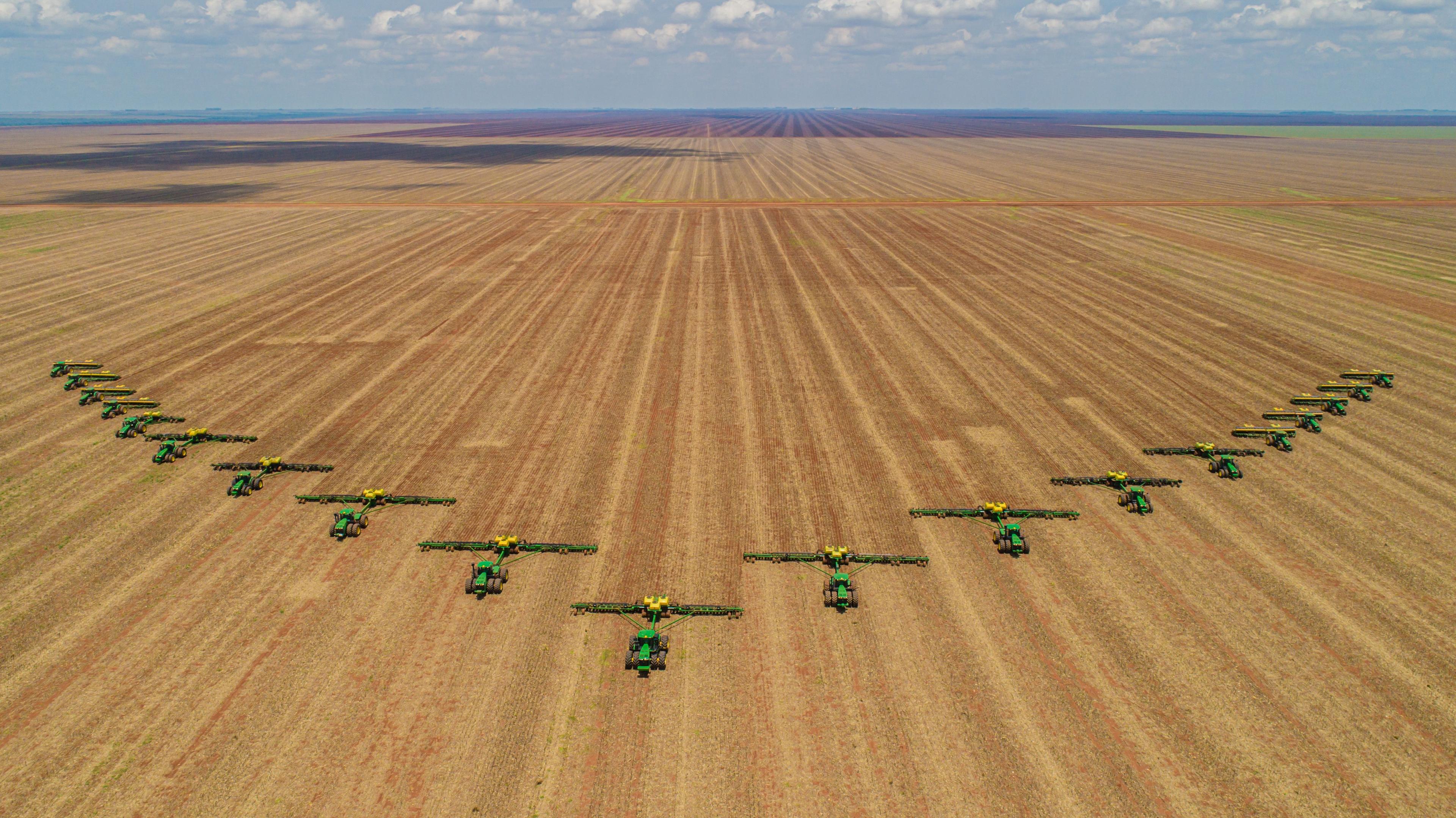 Chapadão do Sul / Mato Grosso do Sul / Brazil / February 26, 2020: Agriculture, Aerial image, number of machines in arrow motion, front of tractors that prepare the land to sow in the field